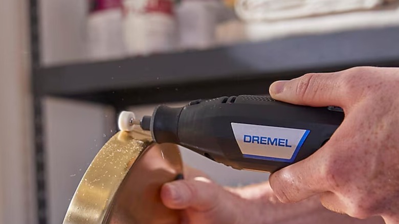 Polishing a workpiece with Dremel rotary tool.