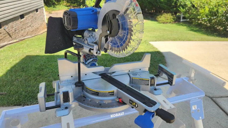 Kobalt Compact Miter Saw on a Kobalt table in a yard.