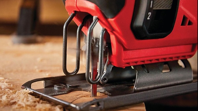 Cutting wooden board with Craftsman jigsaw.