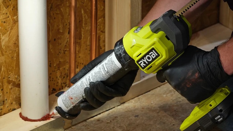 Sealing a pipe with Ryobi adhesive gun.