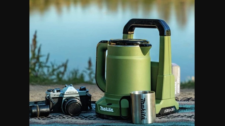 Makita Outdoor Adventure 36V LXT Hot Water Kettle in front of water