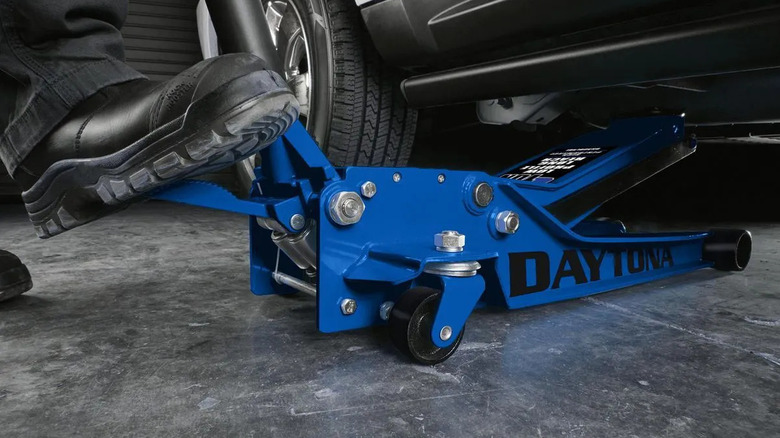 Mechanic using a 3-ton low-profile Daytona jack