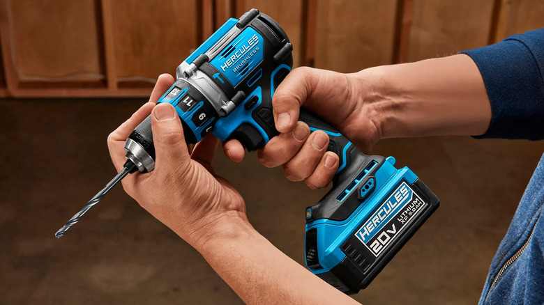 Professional holding a Hercules compact hammer drill/driver