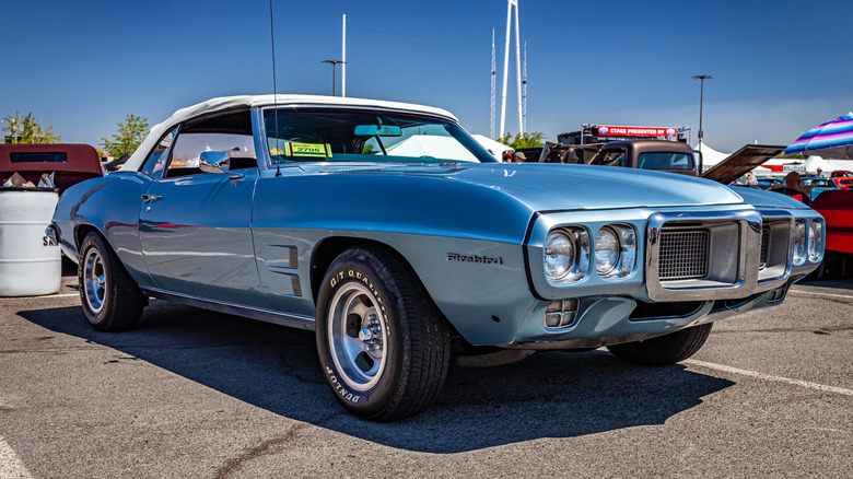Blue Pontiac Firebird in parking lot