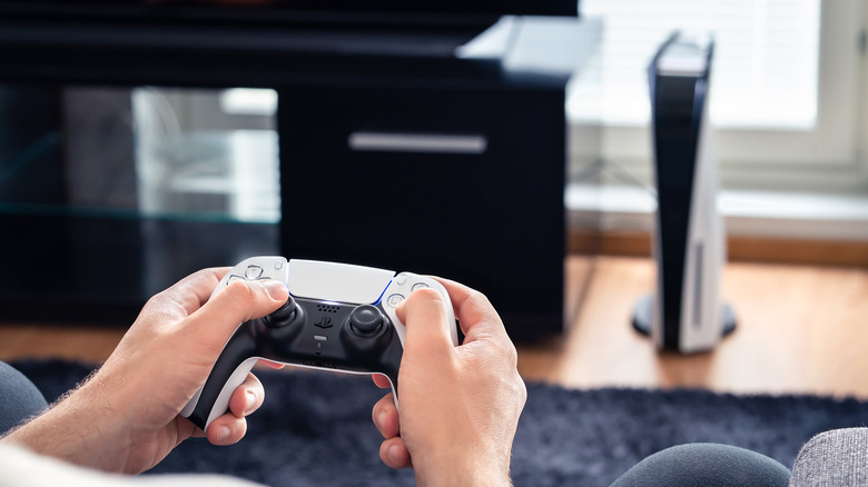 The PS5 sits in the background