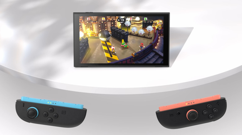 Two Nintendo Switch to Joy-Cons with the main unit propped on a table