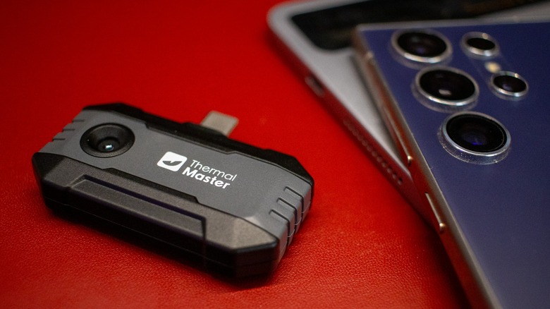 The Thermal Master P1 next to a Samsung phone and Android tablet