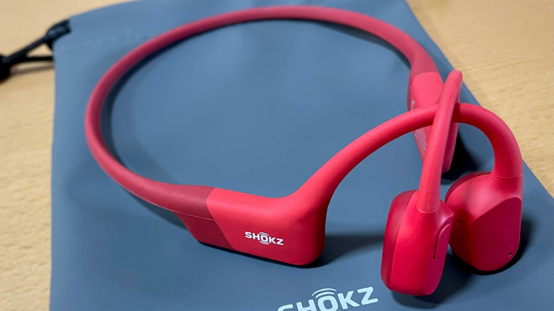 A pair of red Shokz headphones.