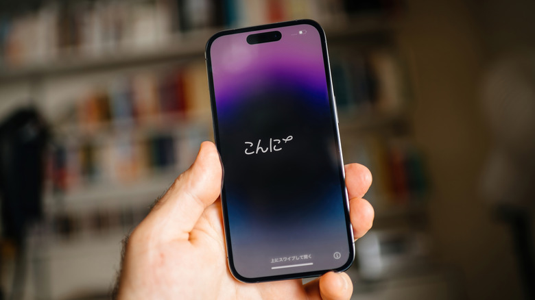 An iPhone held in the hand with the set up screen