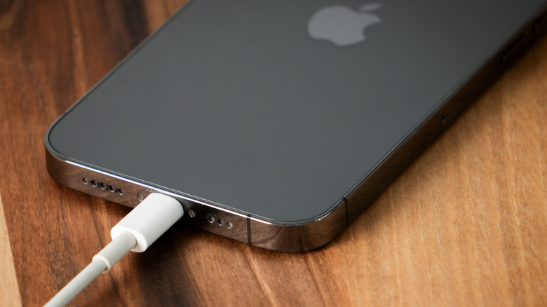 An iPhone with a charger connected to the USB-C port