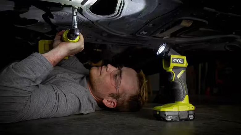 Man works on car with Ryobi LED Light