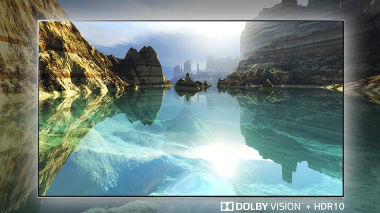A TV screen showing a lake, the words Dolby Vision + HDR10 can be seen in a corner