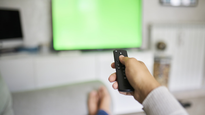 A person using a TV remote