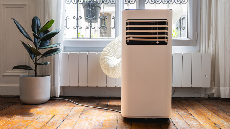 A standing AC unit by a window