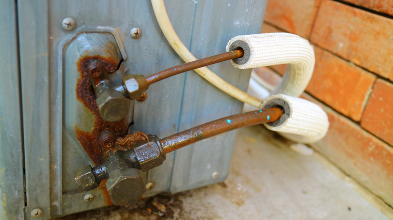 Corrosion visible on refrigerant lines of an outdoor unit