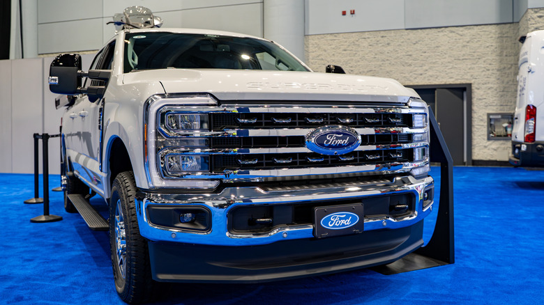 A white 2025 Ford F-350 Super Duty on display