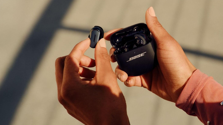 Holding the Bose QuietComfort Ultra Earbuds charging case in hand.