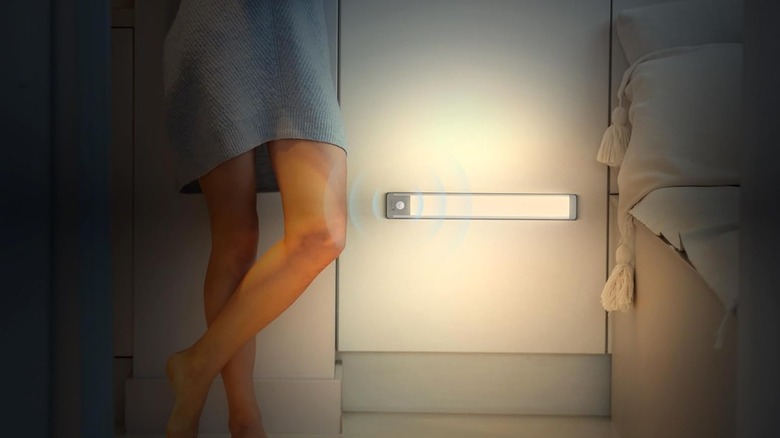 woman standing next to smart light