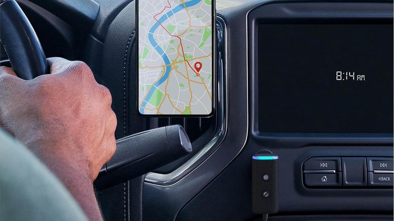 Close up of car dashboard with a smartphone displaying a map