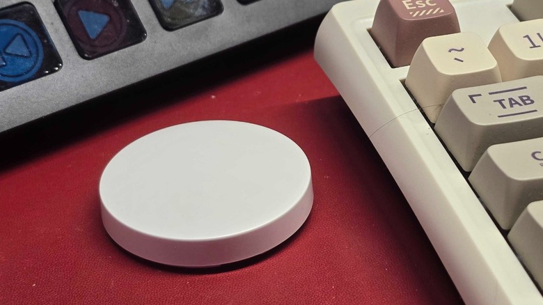 a smart wireless switch next to a keyboard
