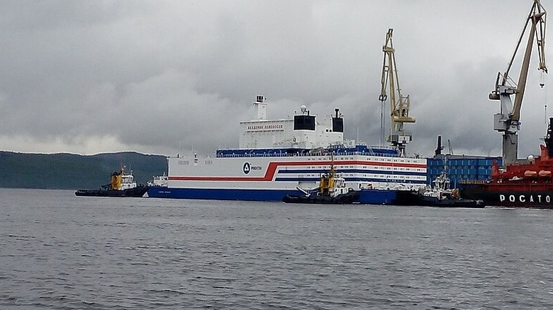 The Akademik Lomonosov, seen in port tugboats around