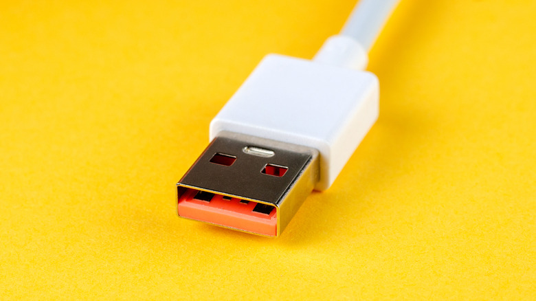 A USB-A cable on bright yellow background.