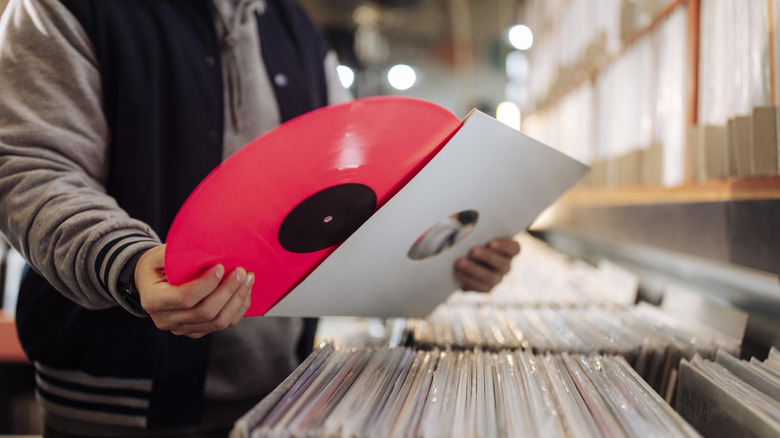 A man browsing through vinyl in a record store.