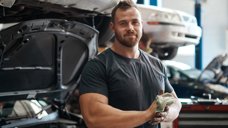 Mechanic holding dirty rag in an auto repair facility.