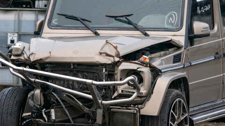 A wrecked Mercedes G-Class with a smashed front end