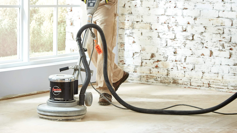 An American Sanders floor sander being used inside a building