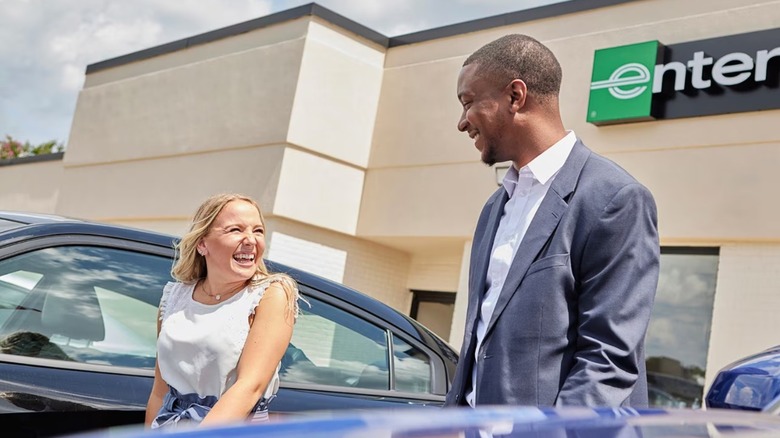 Two people outside an Enterprise car rental agency