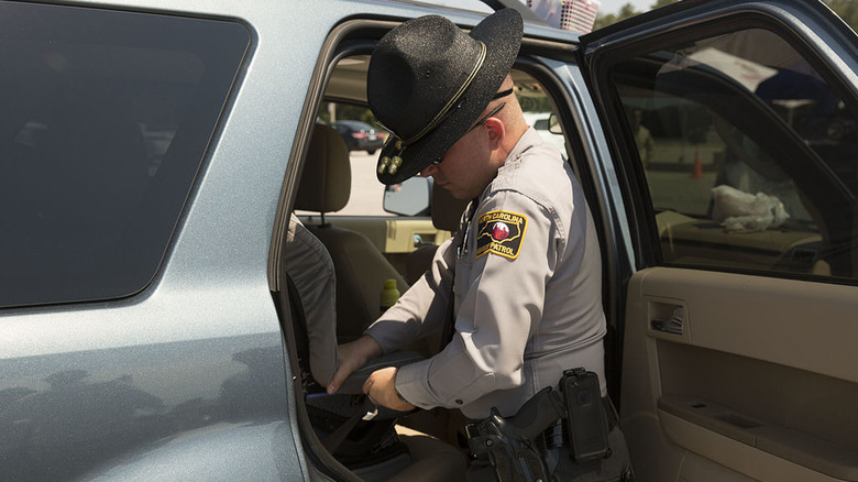North Carolina state trooper installing a car seat