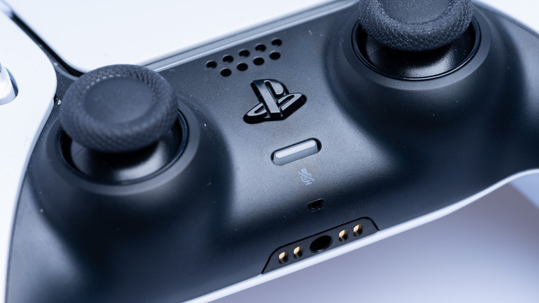A close-up of the mic mute button on a DualSense controller