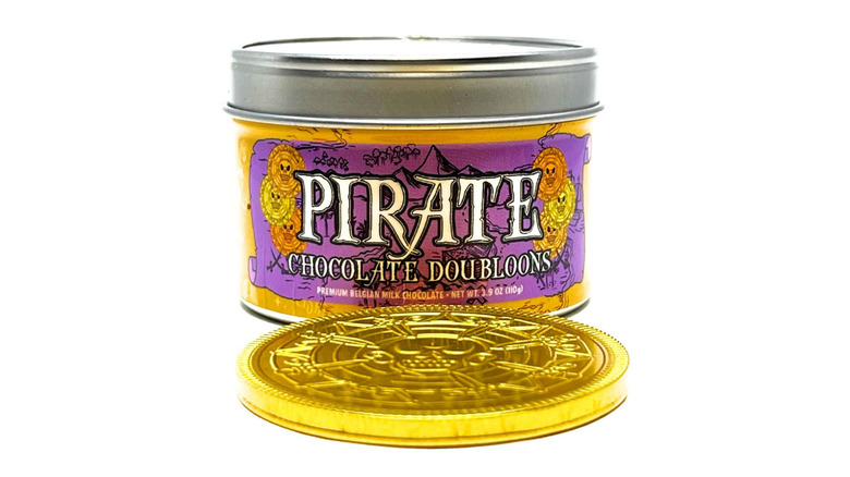 A plastic box labeled "Pirate Chocolate Doubloons" and a chocolate coin in front of it.