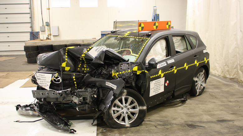 A black Mazda CX-5 crashed by the IIHS during testing