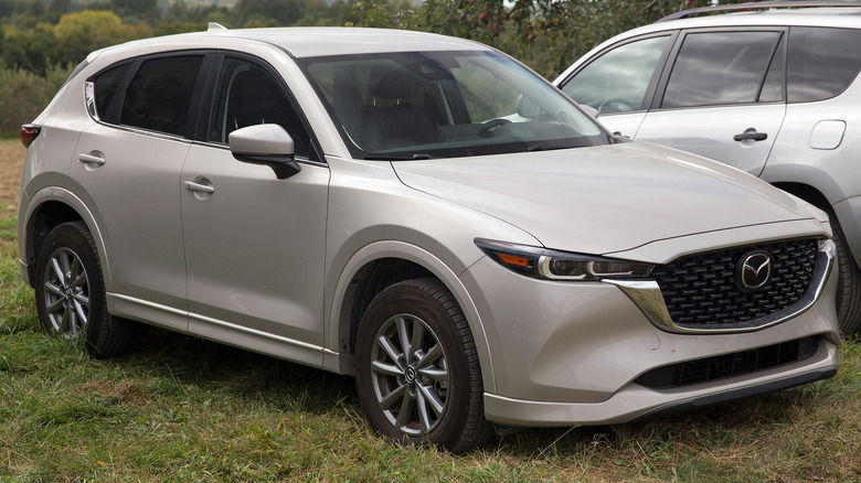 A gray Mazda CX-5 parked in the grass