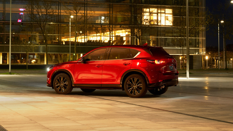 A red Mazda CX-5 in a parking lot at night