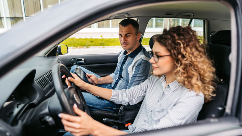 Man grading learner driver