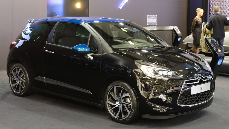 The Citroen DS3 in black at an auto show, front 3/4 view