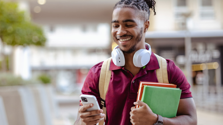 smiling guy using an iphone