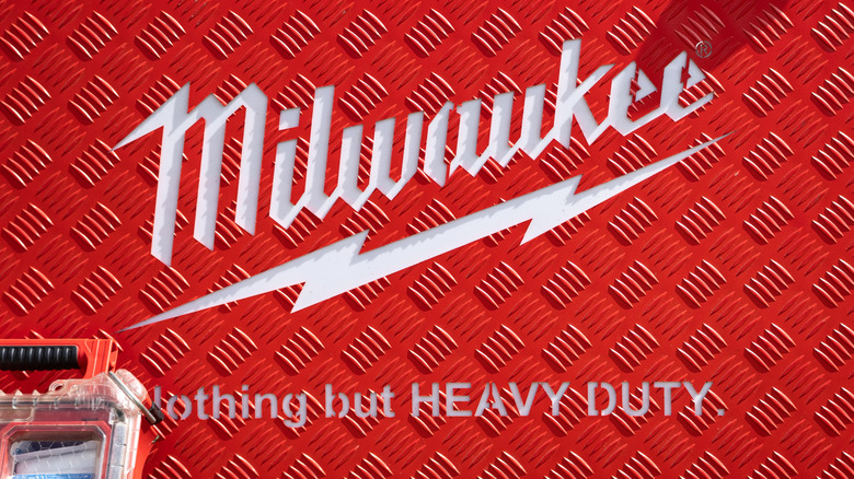 a Milwaukee logo on metal surface with Packout box below