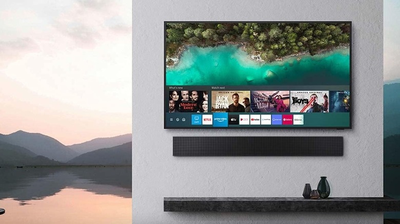 A Samsung outdoor TV mounted on a wall with a sound bar
