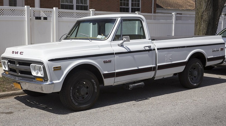 1970 GMC C2500 Sierra Grande Fleetside parked by a sidewalk