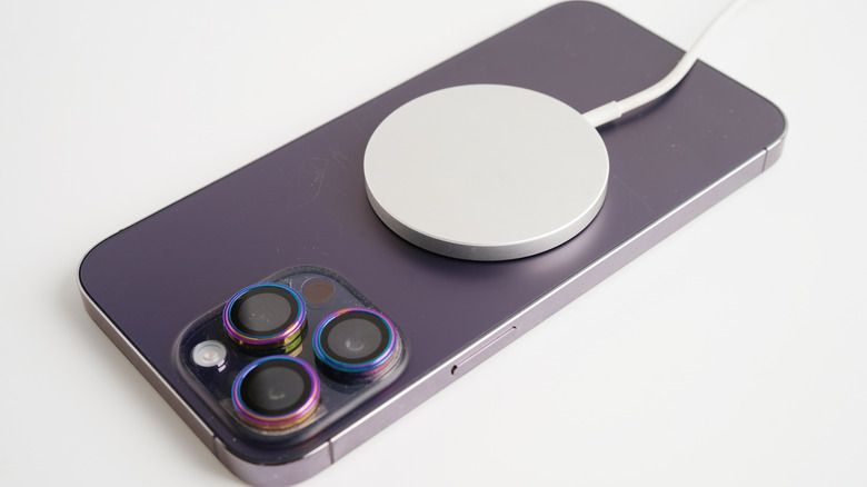 iPhone 14 Pro Max with MagSafe charger attached to the back