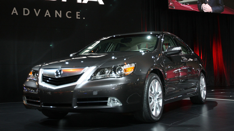 The Acura RL in gray on a show floor, front 3/4 view
