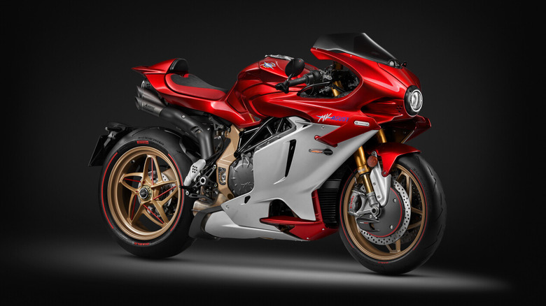 A red and silver MV Agusta Superveloce 1000 Serie Oro sportbike with gold wheels and premium racing components, displayed on a studio black background.
