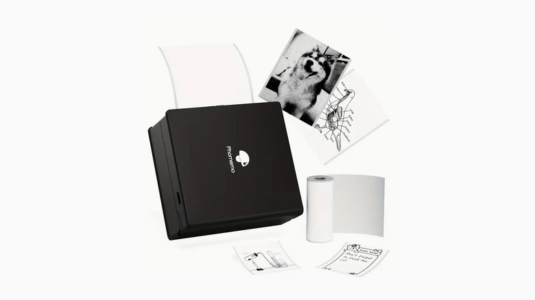 The Phonemo M02 portable mini printer with some prints next to it.