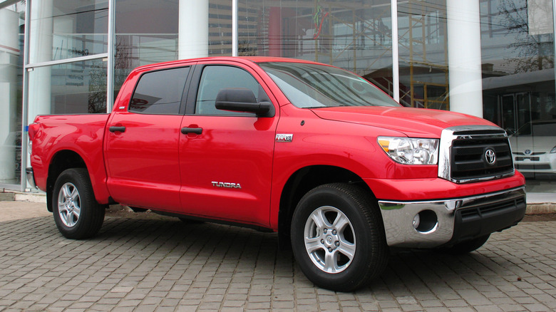 Red 2010 Toyota Tundra SR5 Crew Max parked in front of a building
