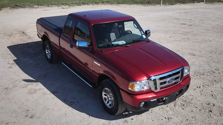 Red 2011 Ford Ranger parked on dirt