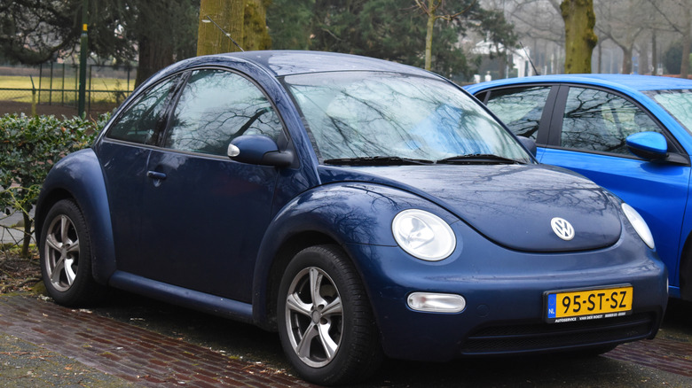 A 2006 Volkswagen Beetle in a parking space